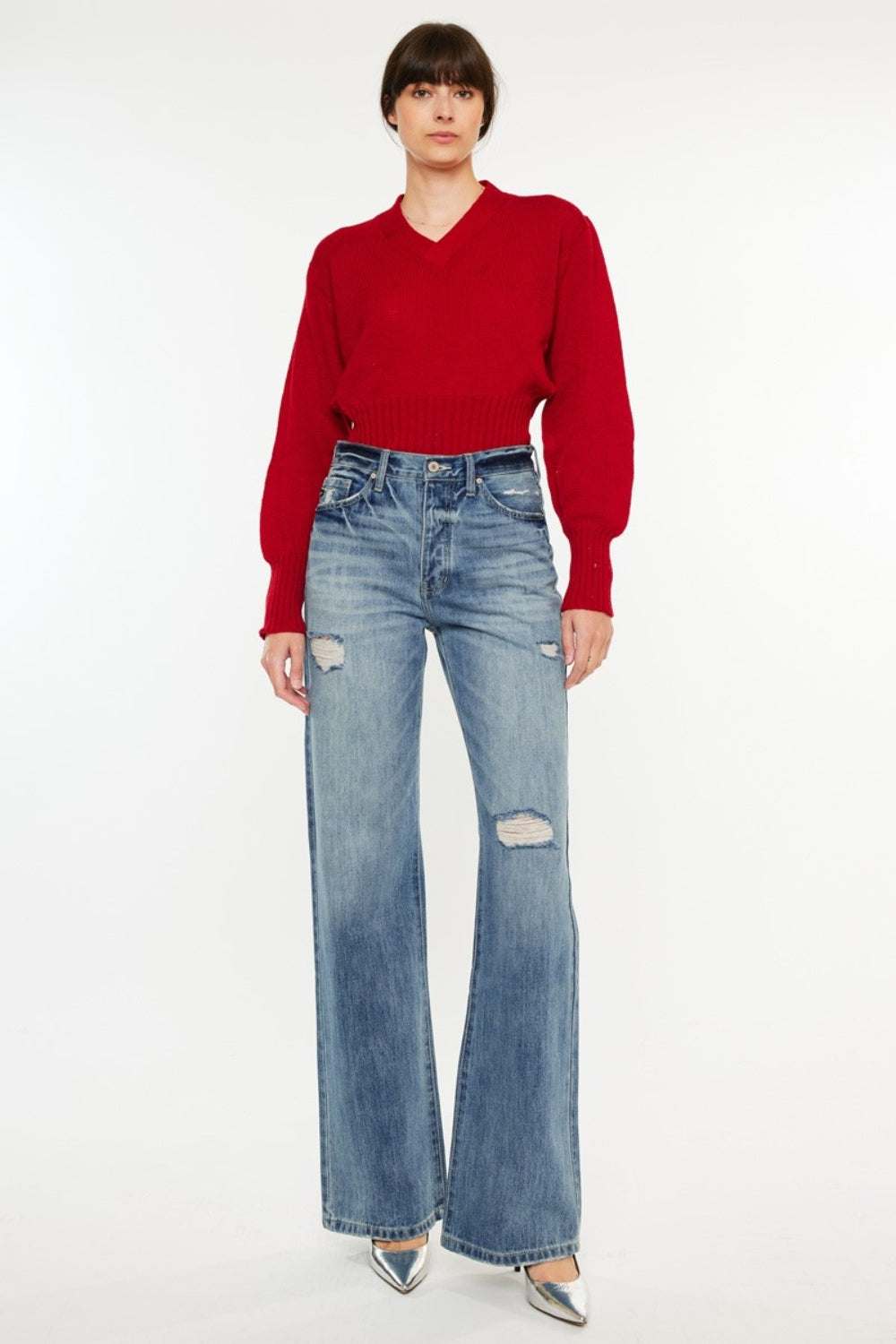 Kancan distressed high waist bootcut jeans on model with red sweater.