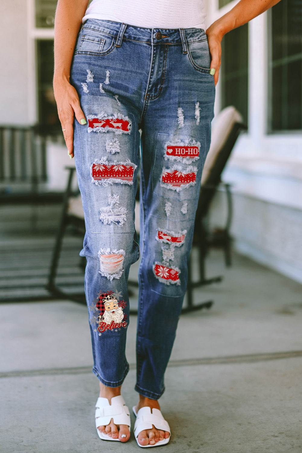 Distressed straight jeans with Santa graphic patches and slight stretch, featuring a cotton-polyester blend.