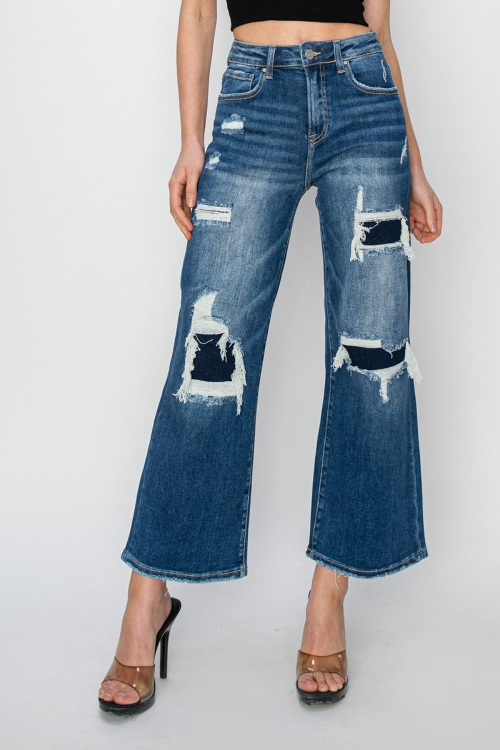 Full size high rise patch detailed wide leg crop jeans, featuring raw hem and pocketed design.