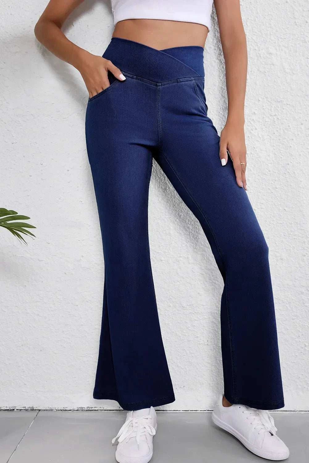 Asymmetric waist flare jeans with moderate stretch and pocket detail.