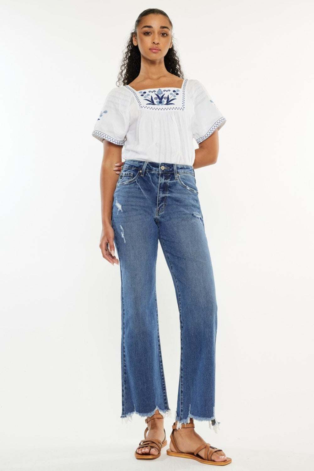 Full size high rise slim wide leg jeans with raw hem in medium wash.