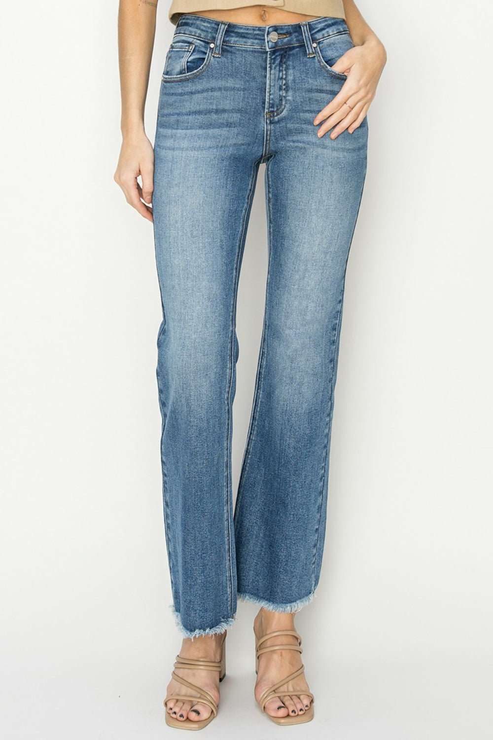 Mid-rise frayed hem bootcut jeans from RISEN, showcasing a trendy fashion-forward style.