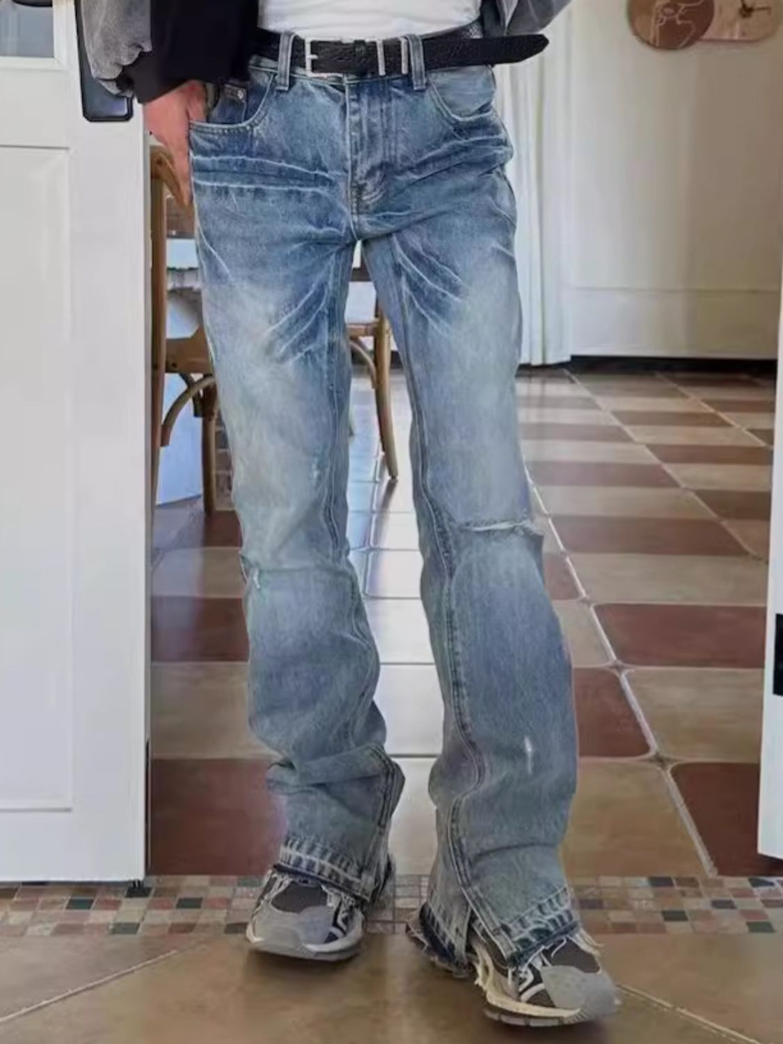 Men's distressed raw hem jeans with a classic, edgy look, crafted from a cotton-polyester blend.