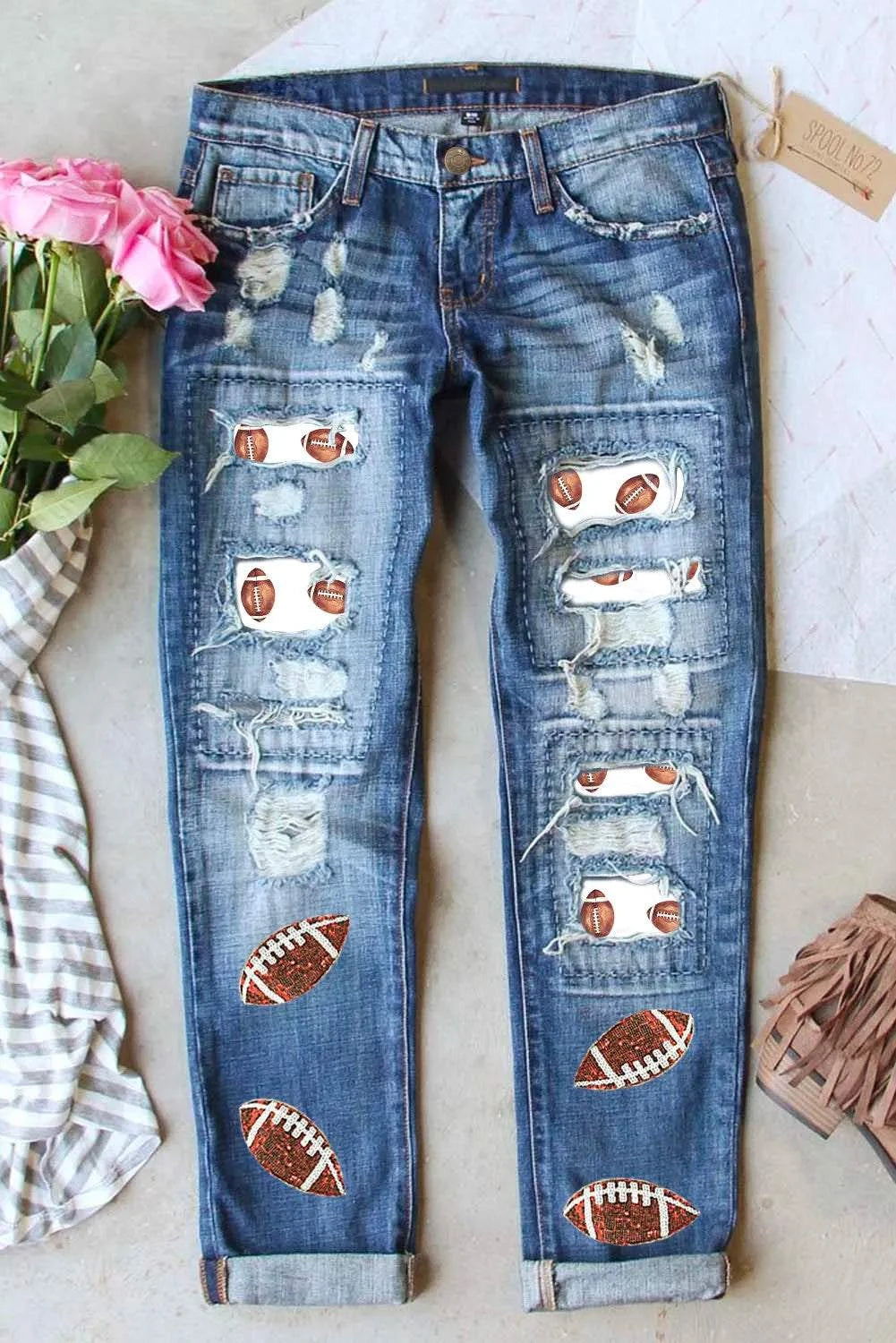 Distressed football-themed jeans with sequin details and slight stretch.