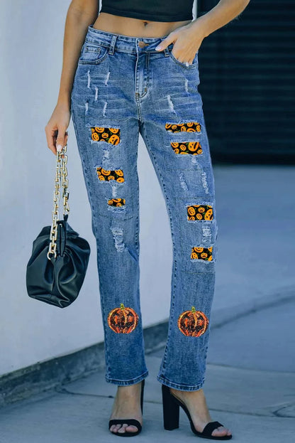 Distressed straight jeans with sequin pumpkin design, slightly stretchy fabric, and unique detailing.