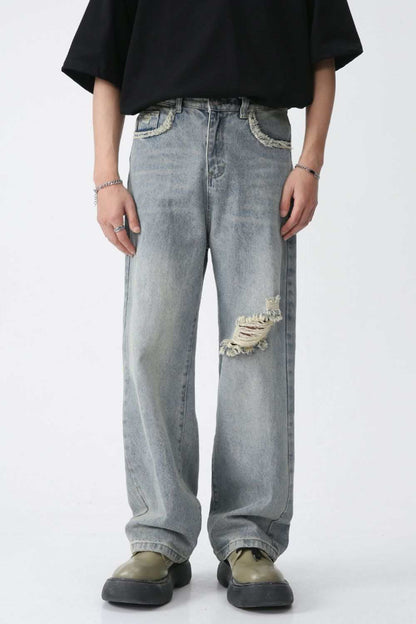 Distressed mid-rise men's jeans with no stretch fabric, featuring basic style and ripped details.