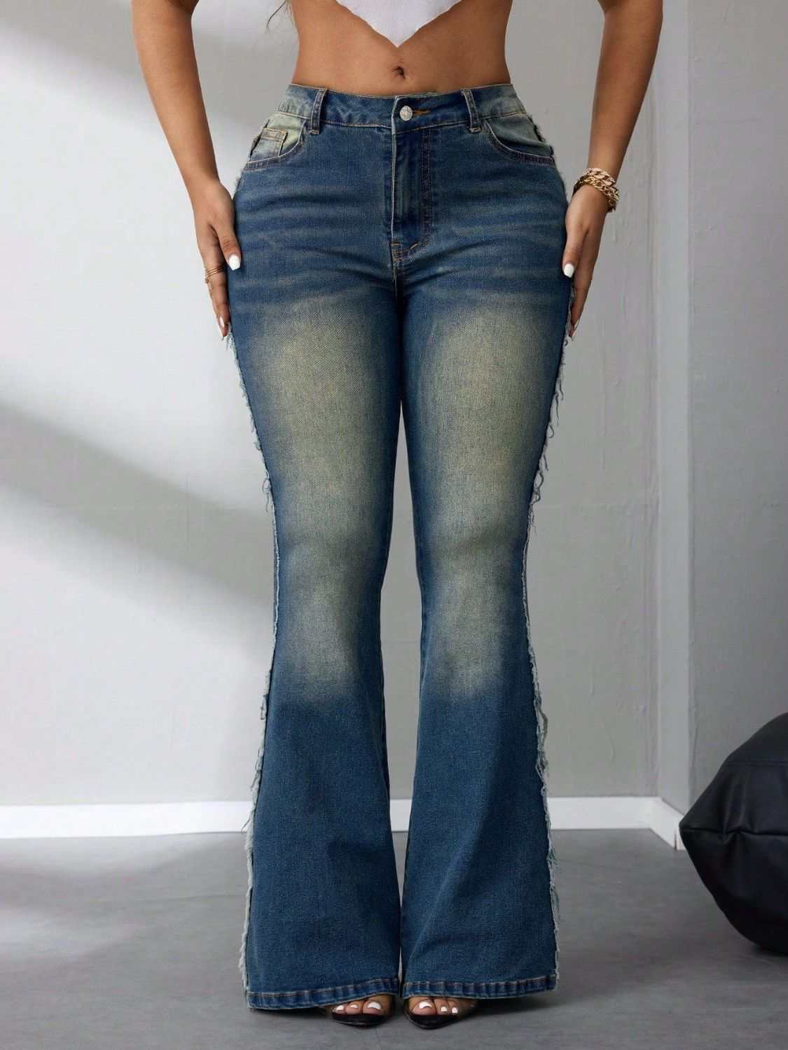 Raw hem flare jeans with buttoned pockets, no stretch, in blue denim.