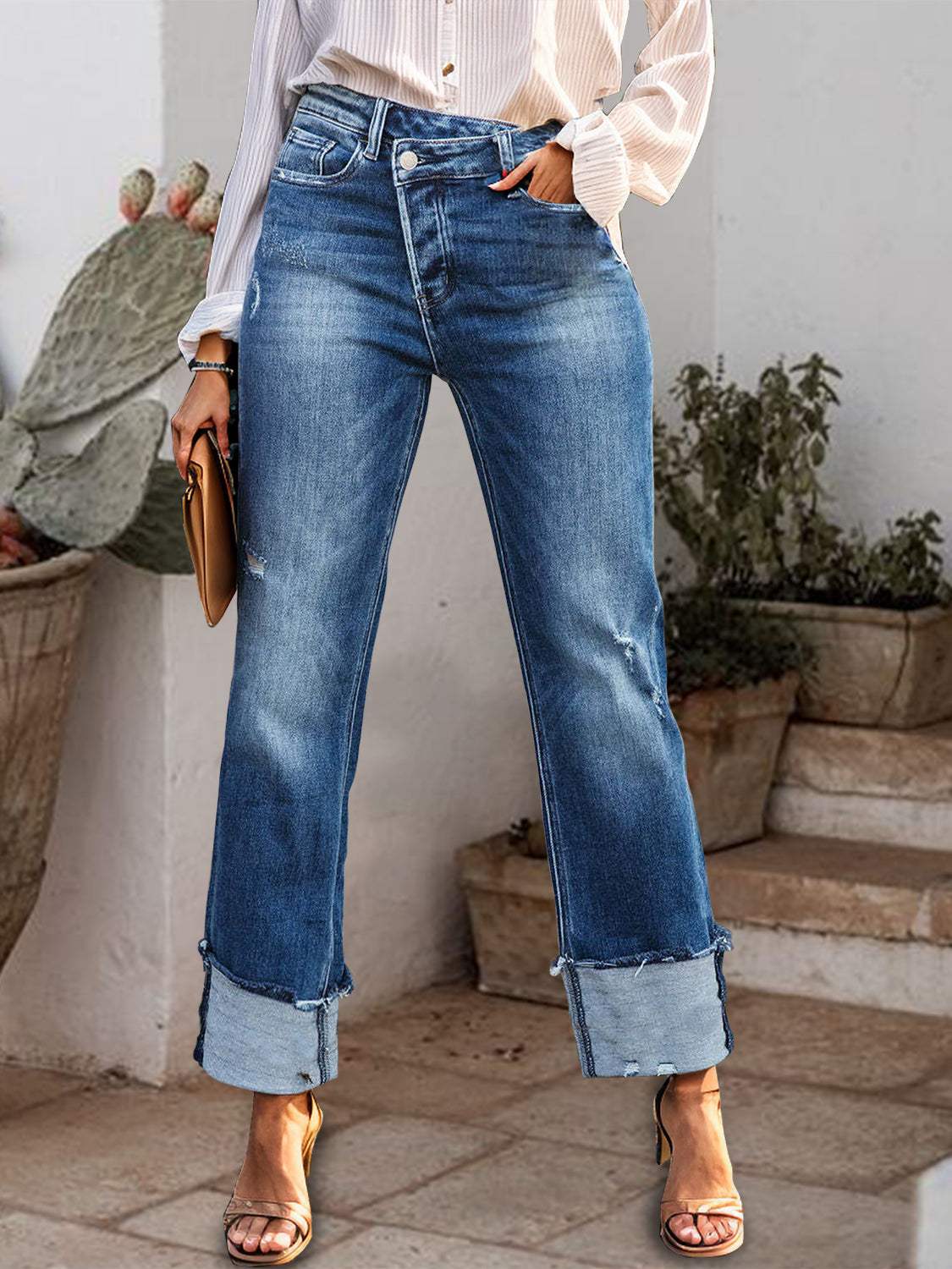 Stepped Waist Raw Hem Rolled Straight Jeans with buttoned detail and slight stretch, composed of 65% cotton and 35% polyester.