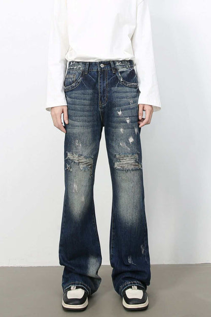 Men's distressed jeans with no stretch, made from cotton, viscose, and polyester blend.