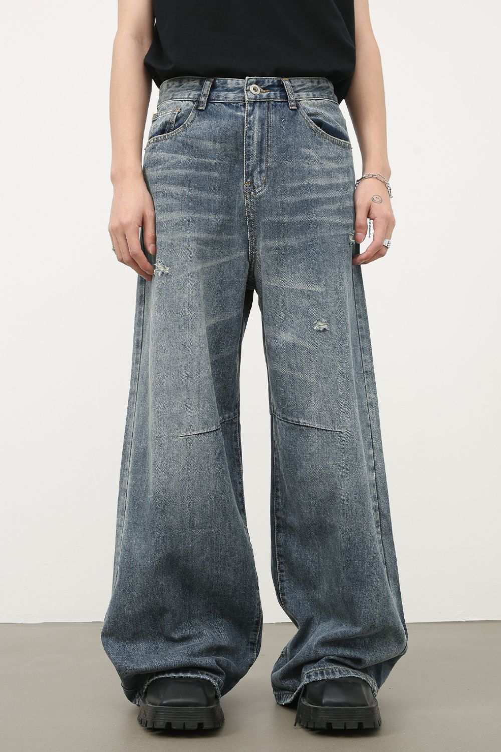Men's distressed wide leg jeans with slightly stretchy denim.