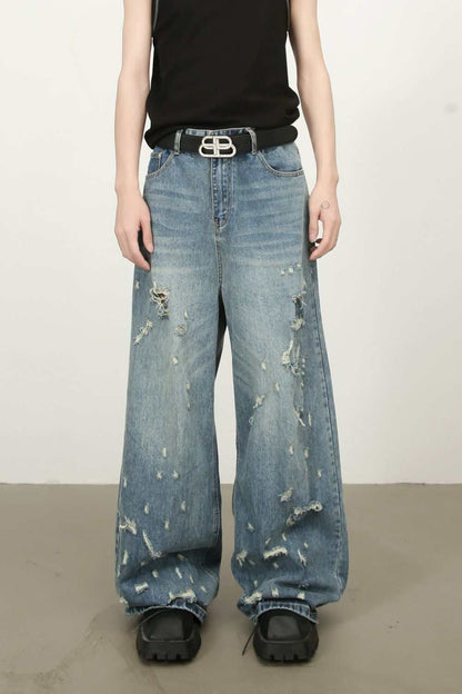 Men's distressed wide leg jeans with no stretch, featuring a basic style and distressed details, made of cotton, viscose, and polyester.