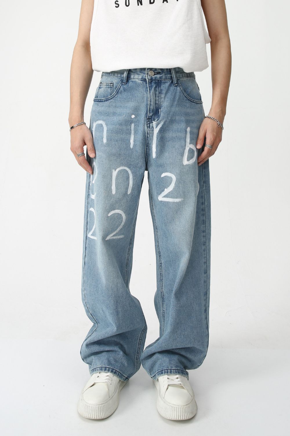 Men's Graffiti Wide Leg Jeans with white graffiti design, showcasing a relaxed fit and blue denim fabric.