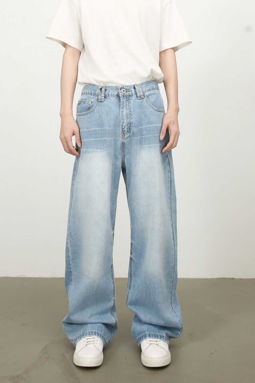 Men's mid rise wide leg jeans with pockets in light blue denim.