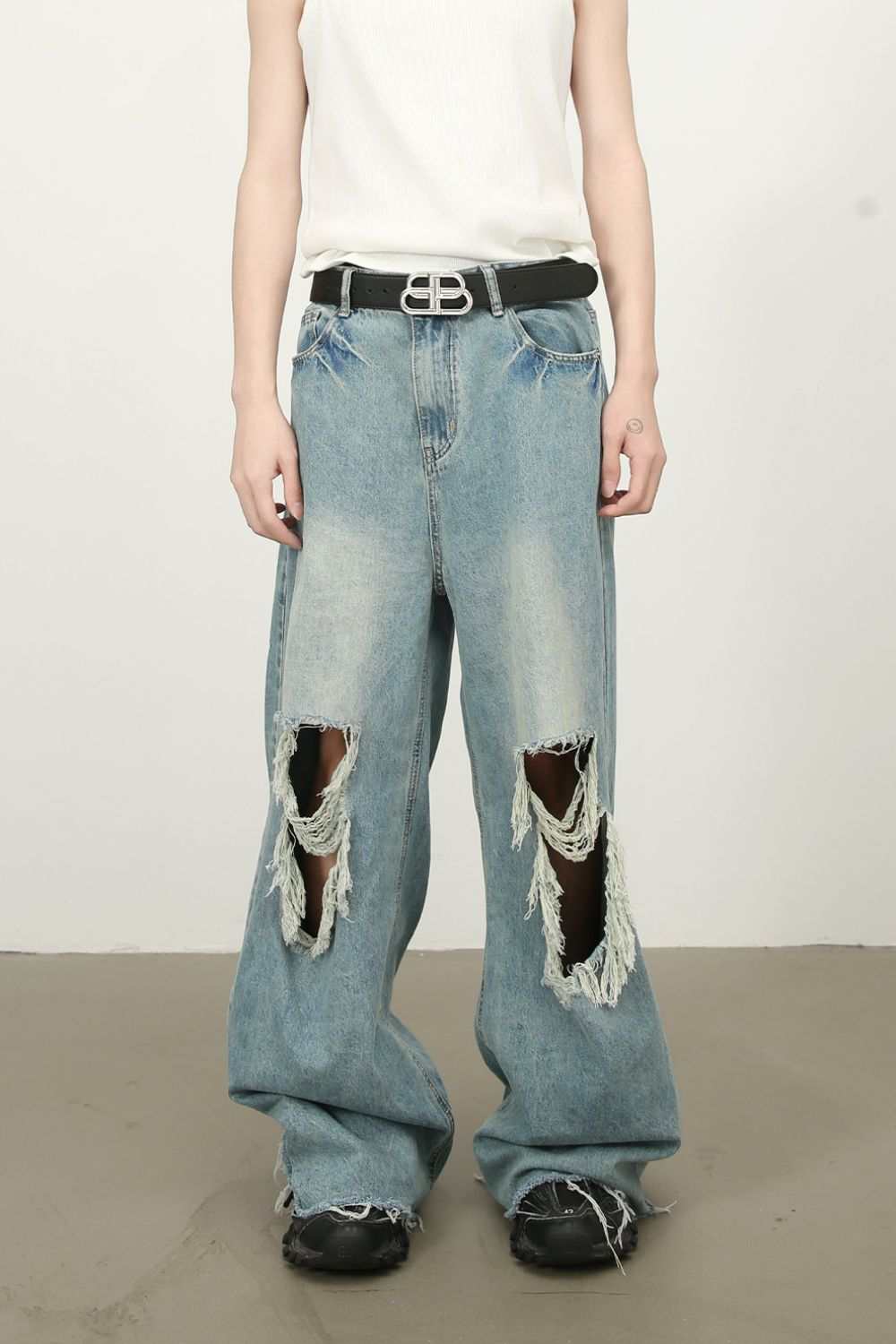 Men's raw hem distressed jeans with no stretch, featuring cotton, viscose, and polyester blend.