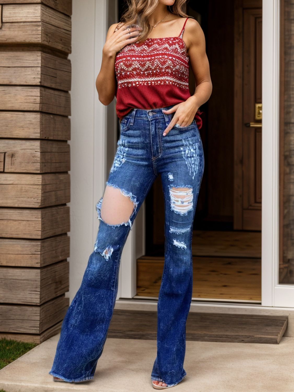 Woman wearing raw hem distressed bootcut jeans.