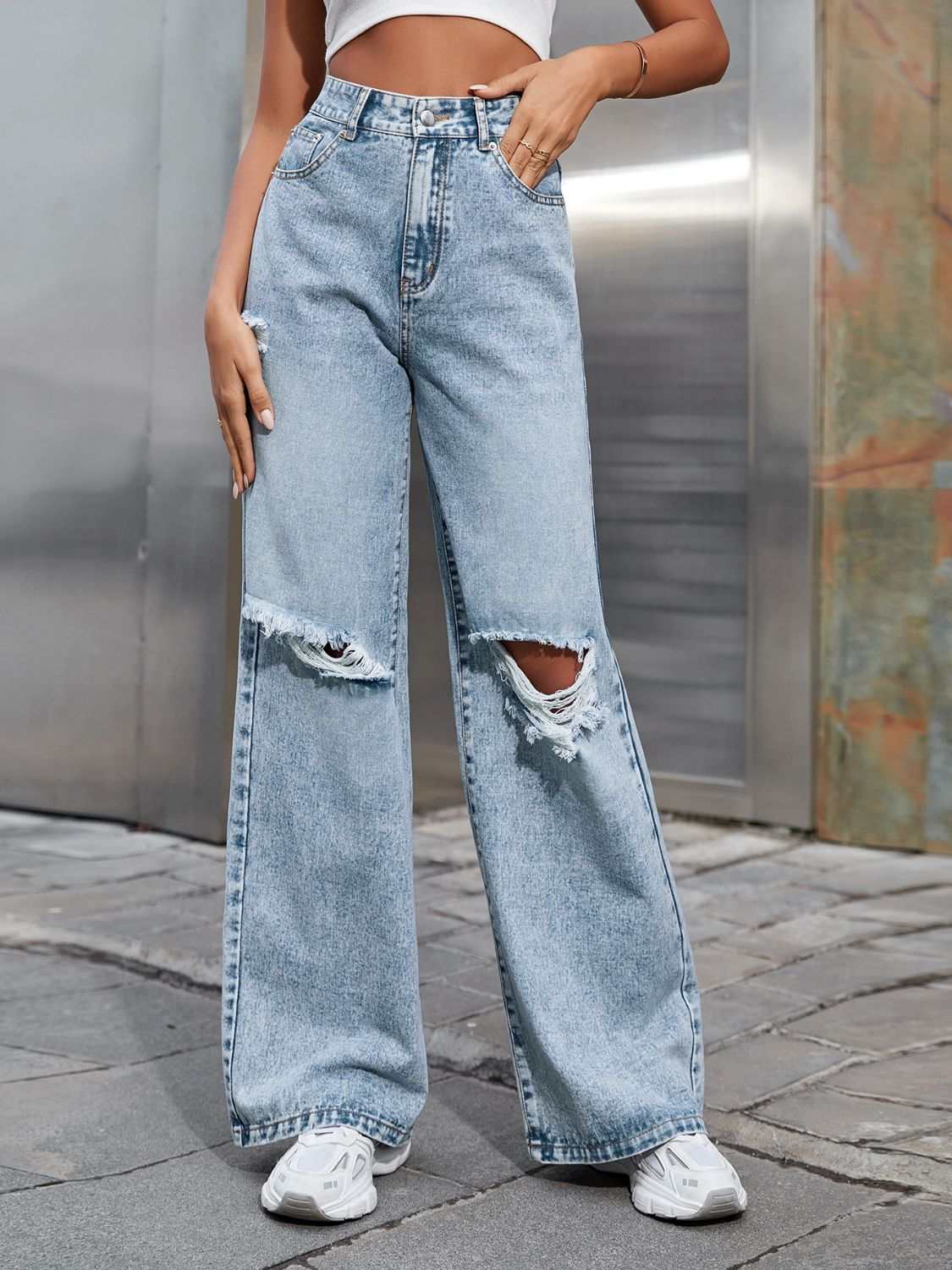 Distressed wide leg jeans with pockets and ripped details.