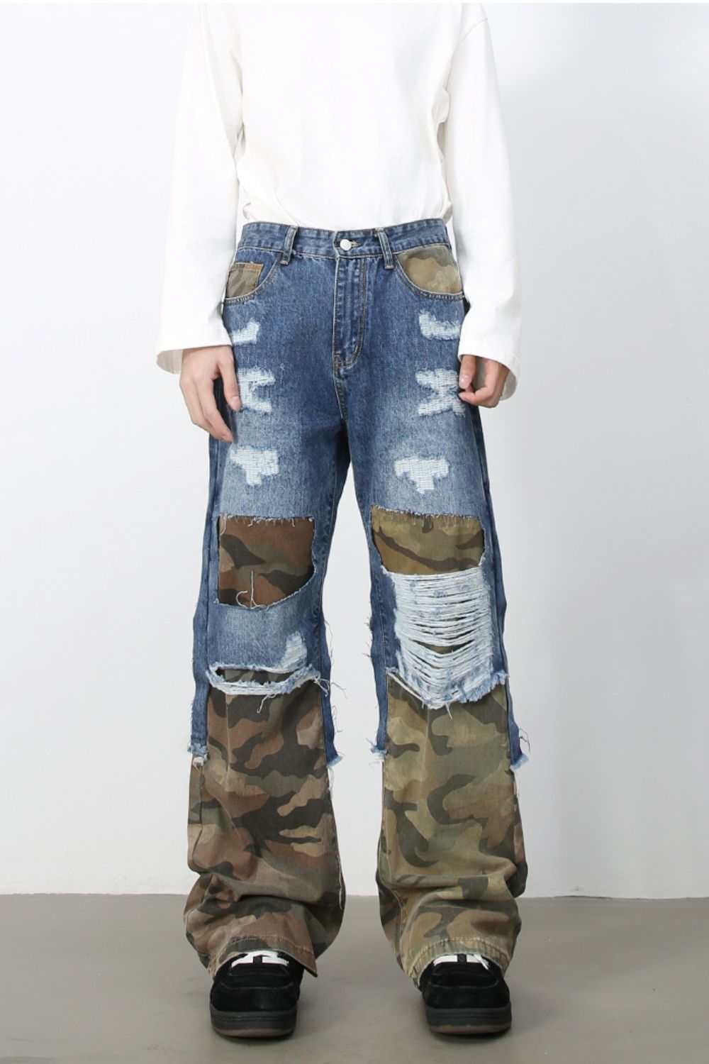 Men's distressed camouflage jeans with raw hem and no stretch.