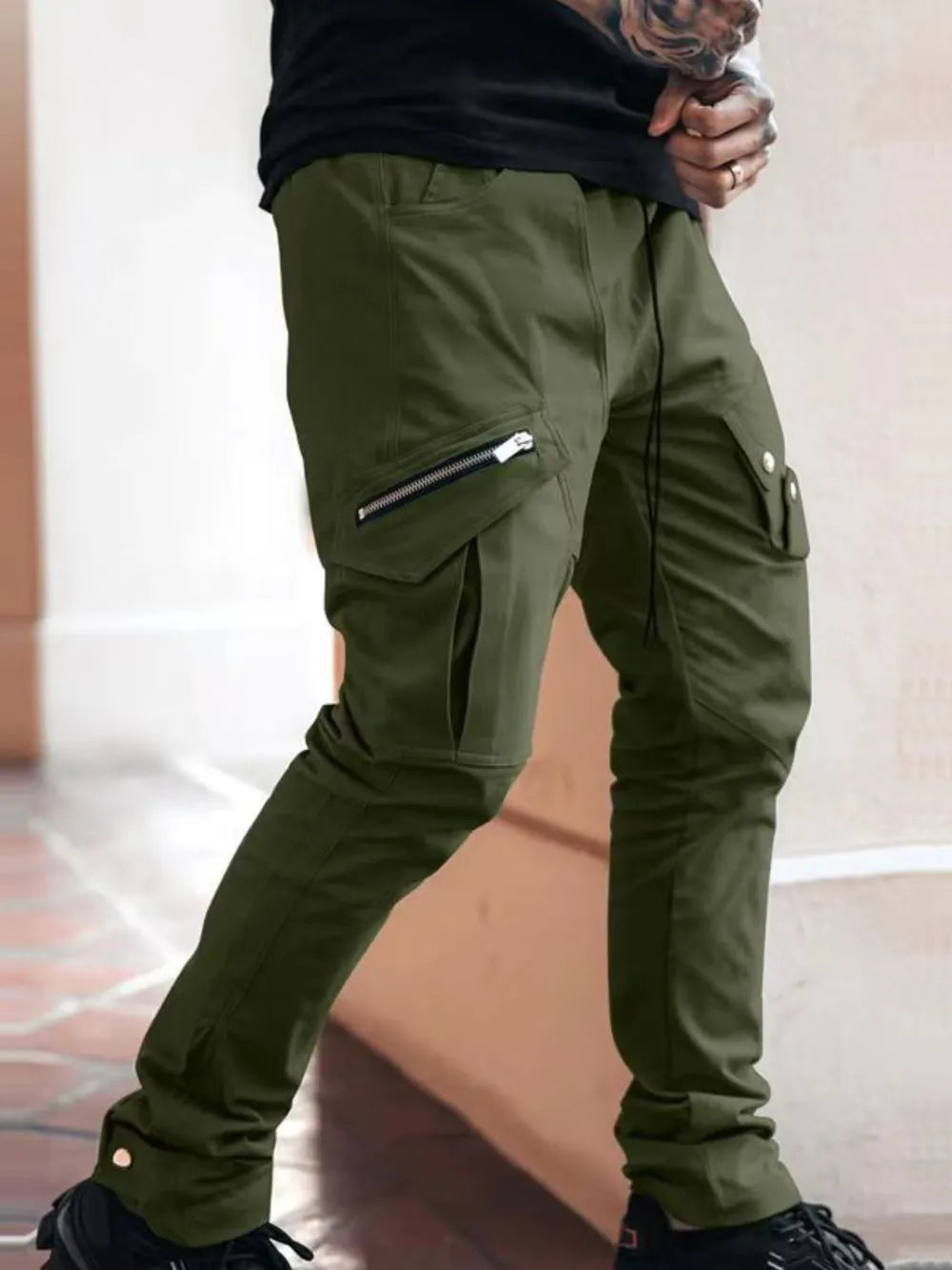 Men's plus size cargo pants in olive green with zipper pockets.