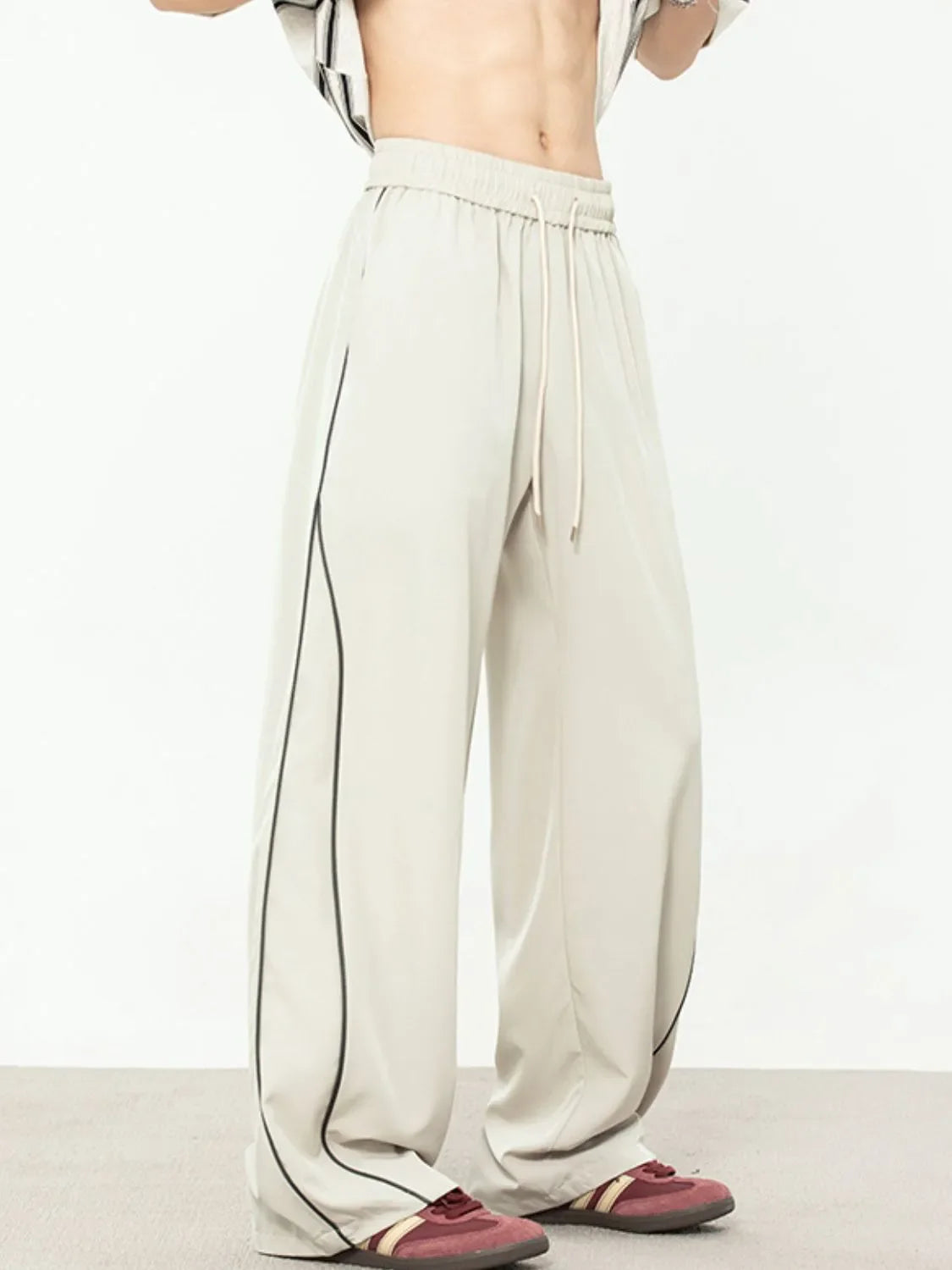 Men's contrast straight sweatpants with black piping, polyester-spandex blend.