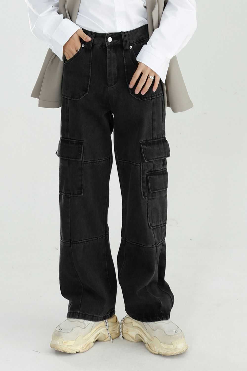 Baggy jeans with cargo pockets in black, no stretch, cotton blend, worn with beige and white top.