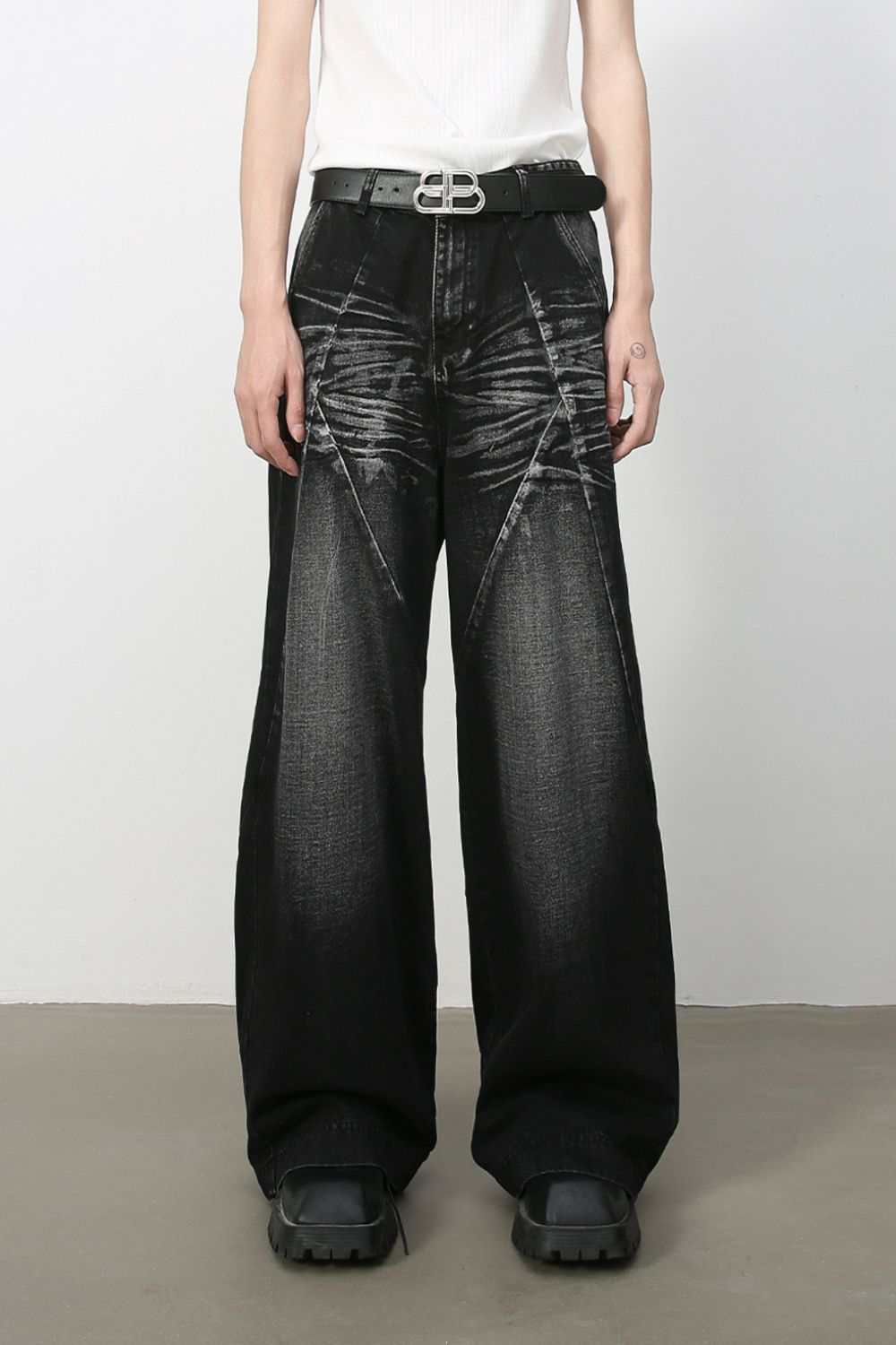 Men's wide leg jeans with pockets, cat's whisker detail, washed black finish.