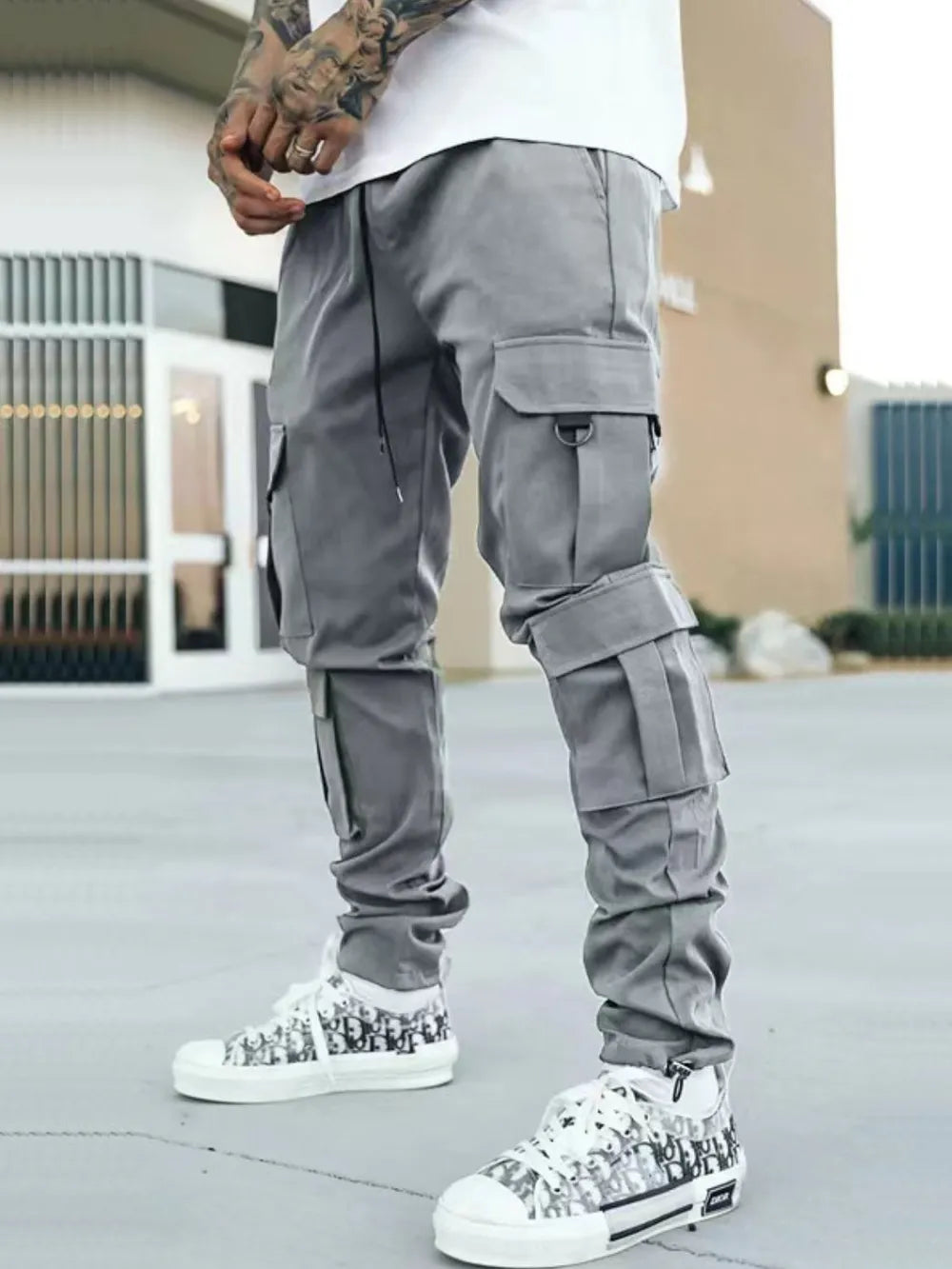 Men's drawstring cargo pants with pockets in a basic style, polyester-spandex blend.