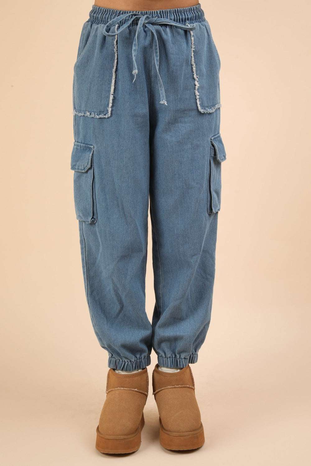 Washed drawstring jogger cargo jeans with pockets and elastic waist.
