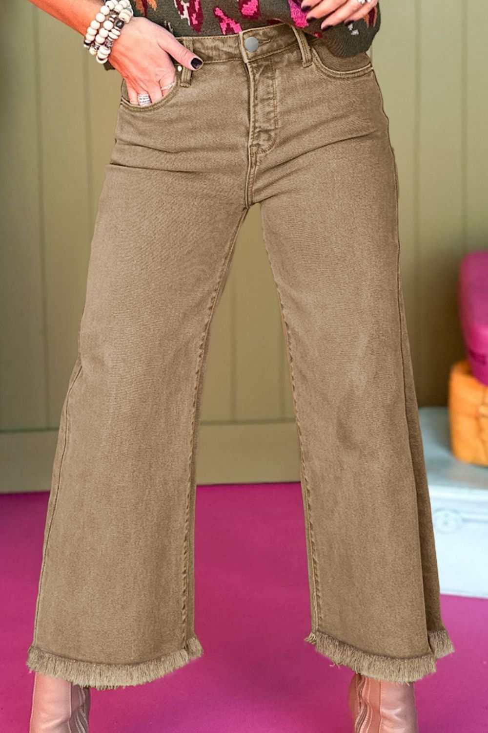 Wide leg jeans with raw hem and pocket detail.