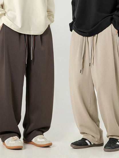 Men's plus size drawstring wide leg pants in dark and light colors.