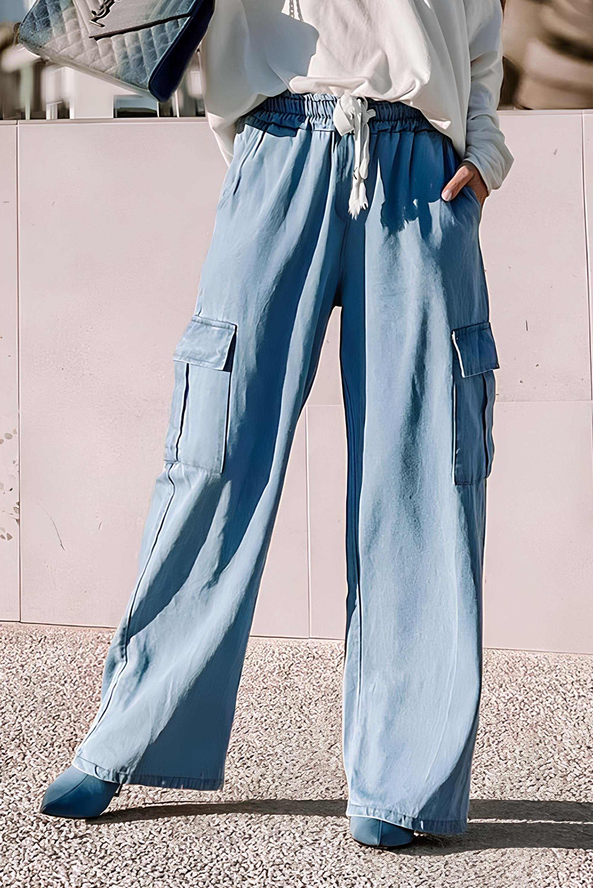 Wide leg jeans with drawstring and cargo pockets, light blue, 100% lyocell material.