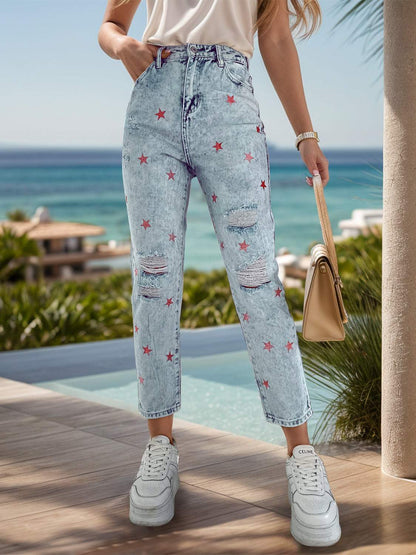 Distressed star jeans with pockets by the beach.