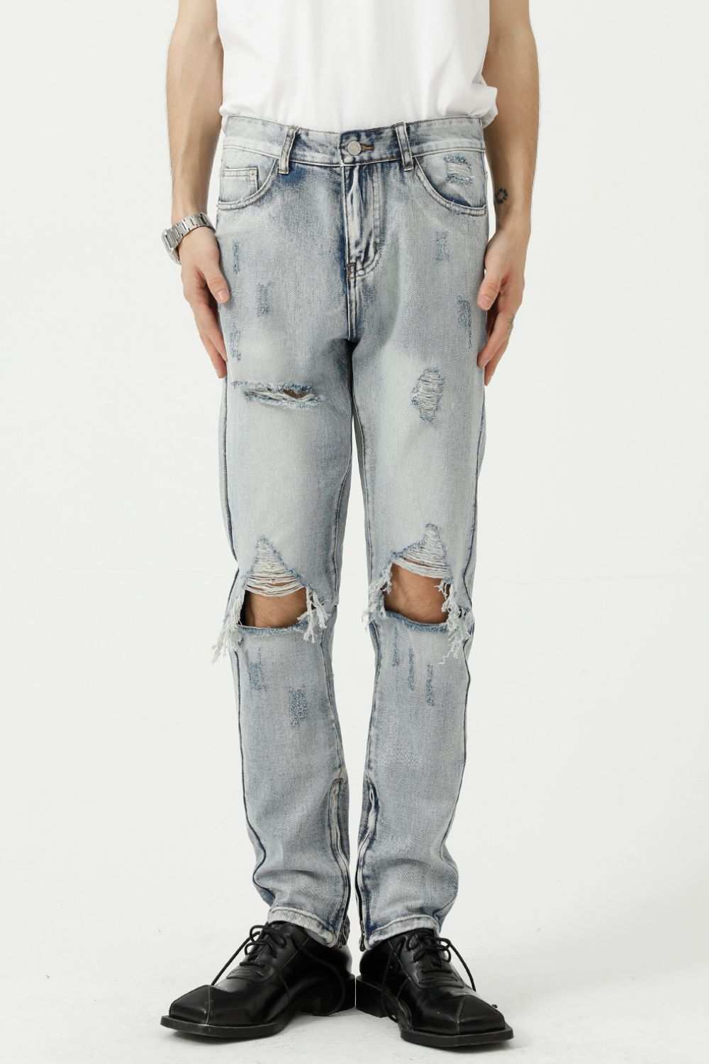 Distressed side zip jeans with pockets, featuring ripped details and no stretch, made from 95% cotton and 5% polyester.