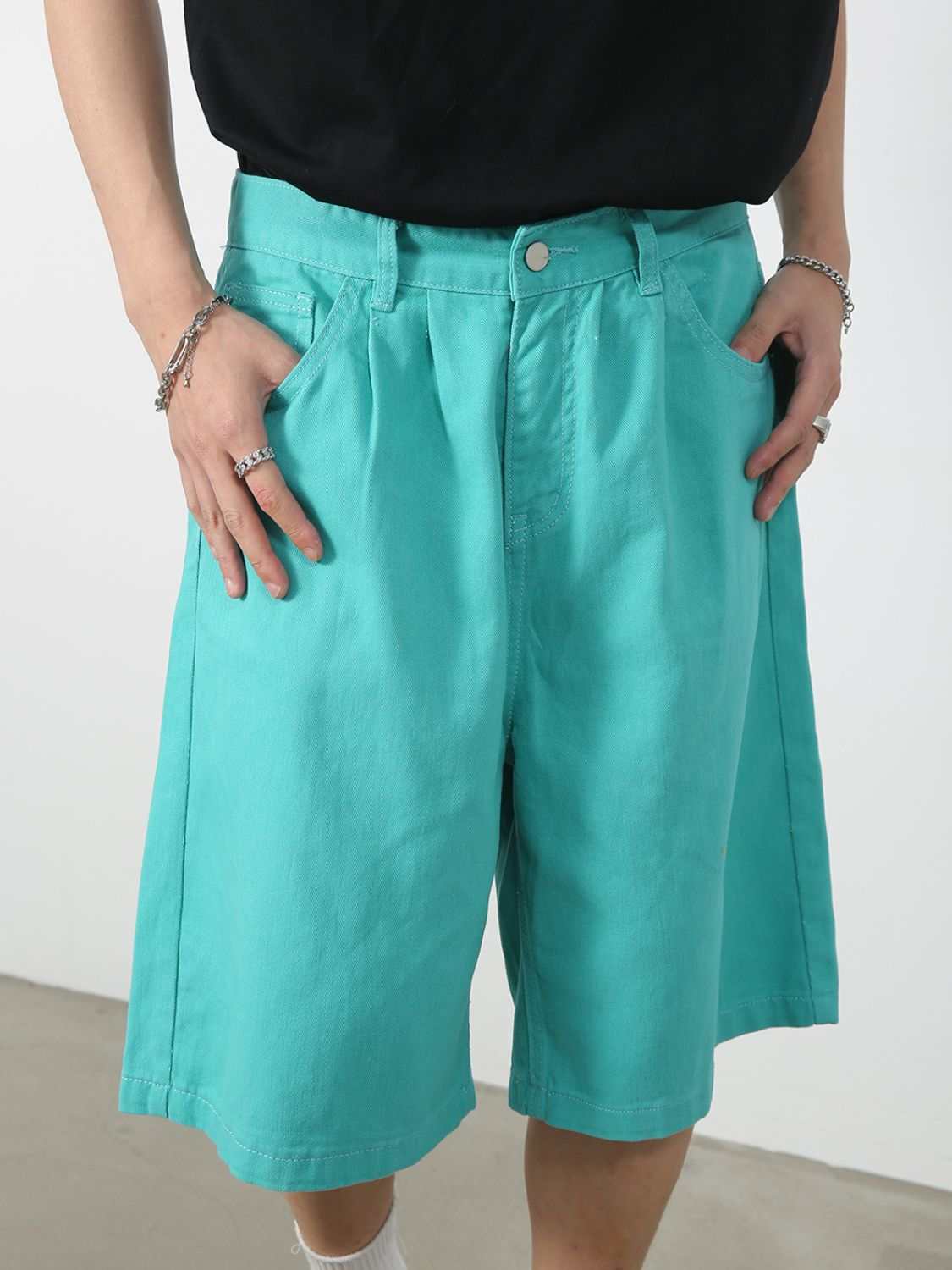 Mid rise denim shorts, basic style with pockets and button, turquoise color.