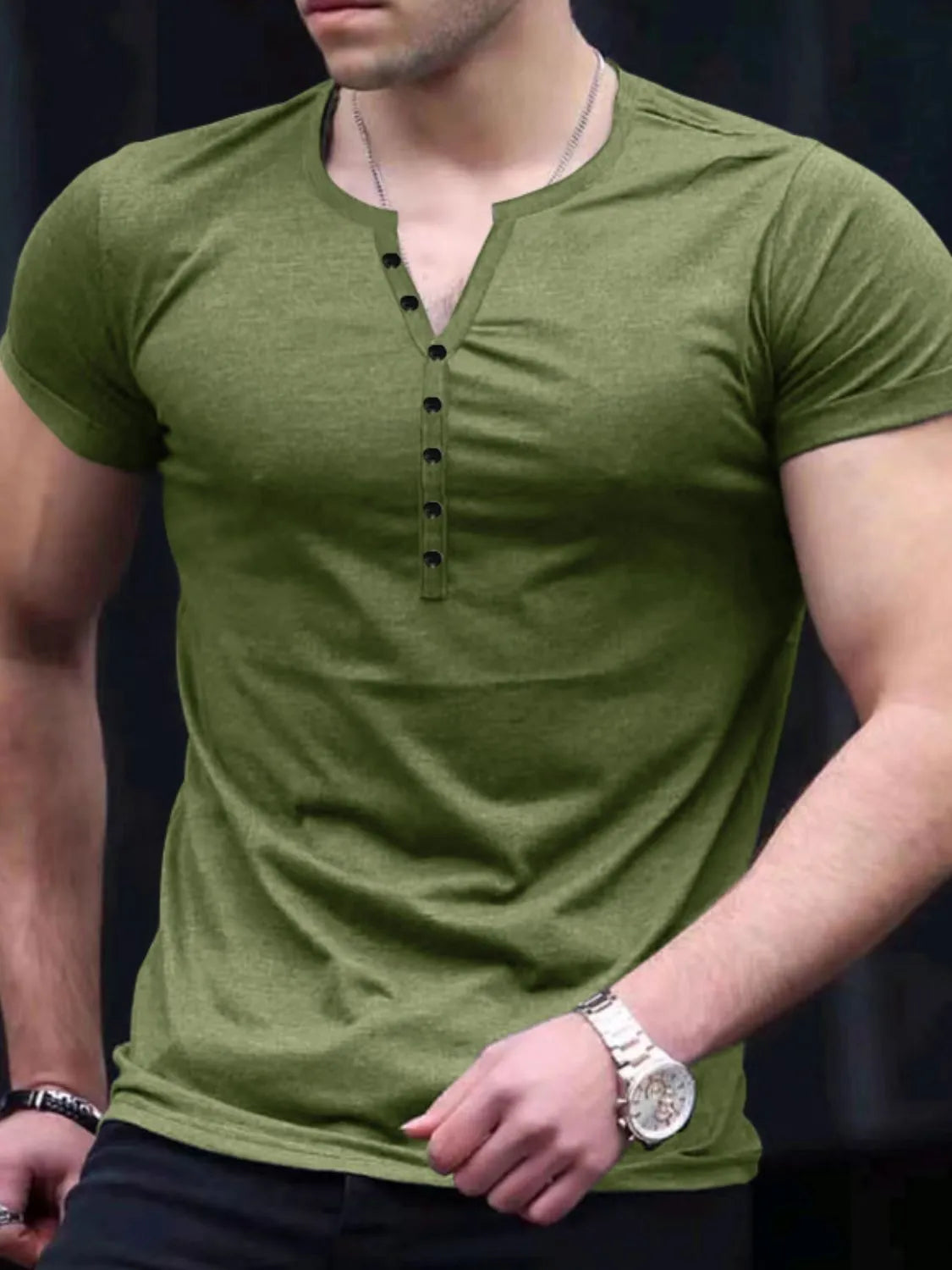 Men's green short sleeve top with button detail, slightly stretchy fabric.