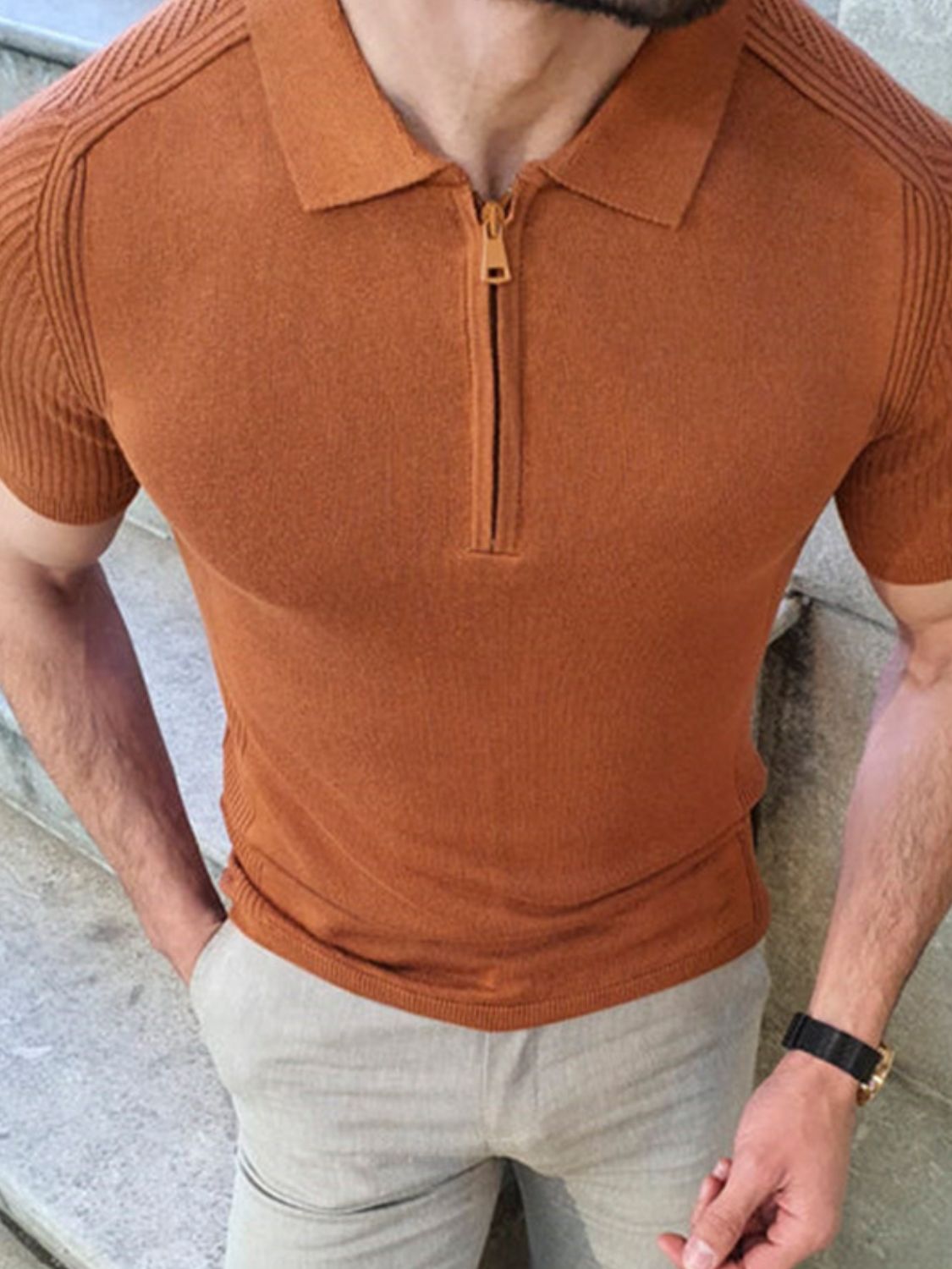 Men's collared neck quarter zip knit polo in brown, slightly stretchy material.