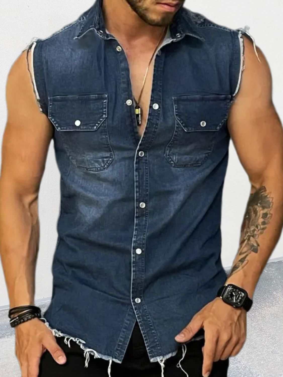 Men's sleeveless denim shirt with snap down buttons and pockets.