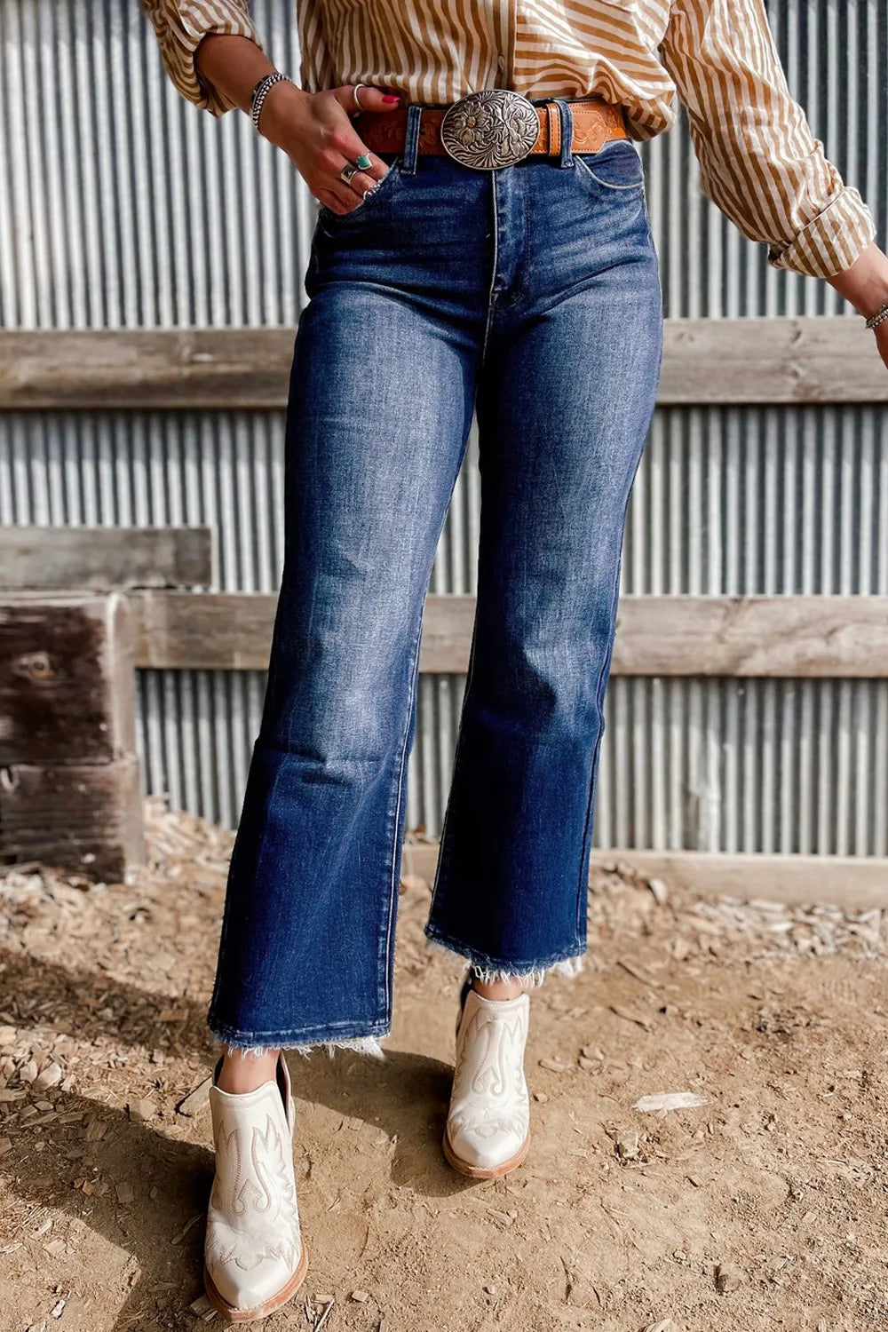Mineral wash high waist flared jeans with raw hem and no stretch.