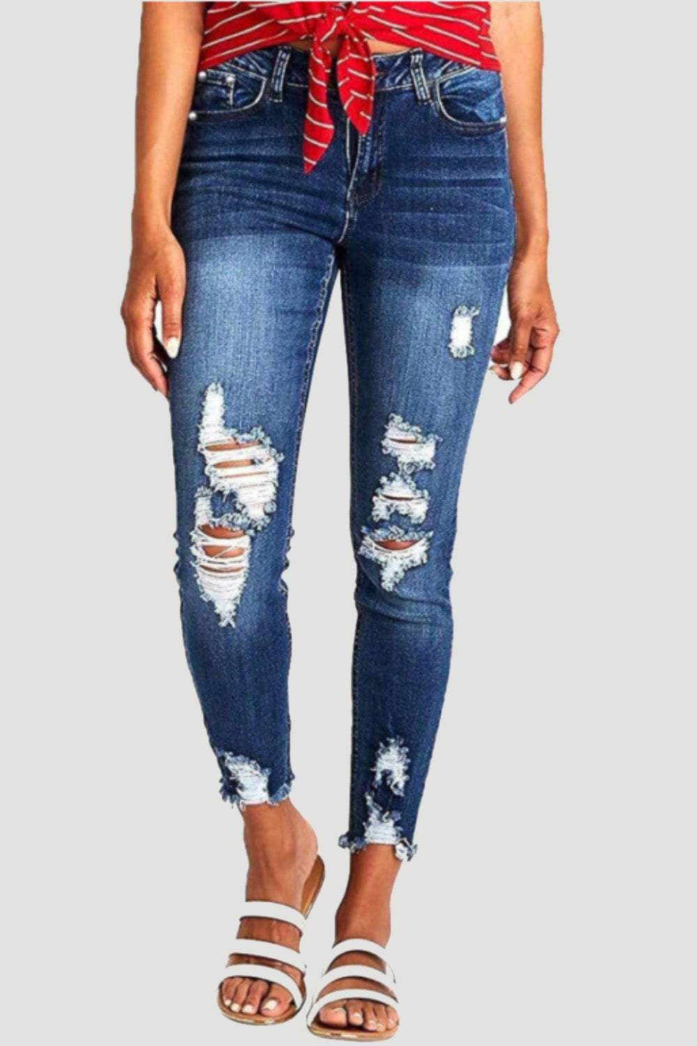 Distressed raw hem jeans with pockets and moderate stretch.