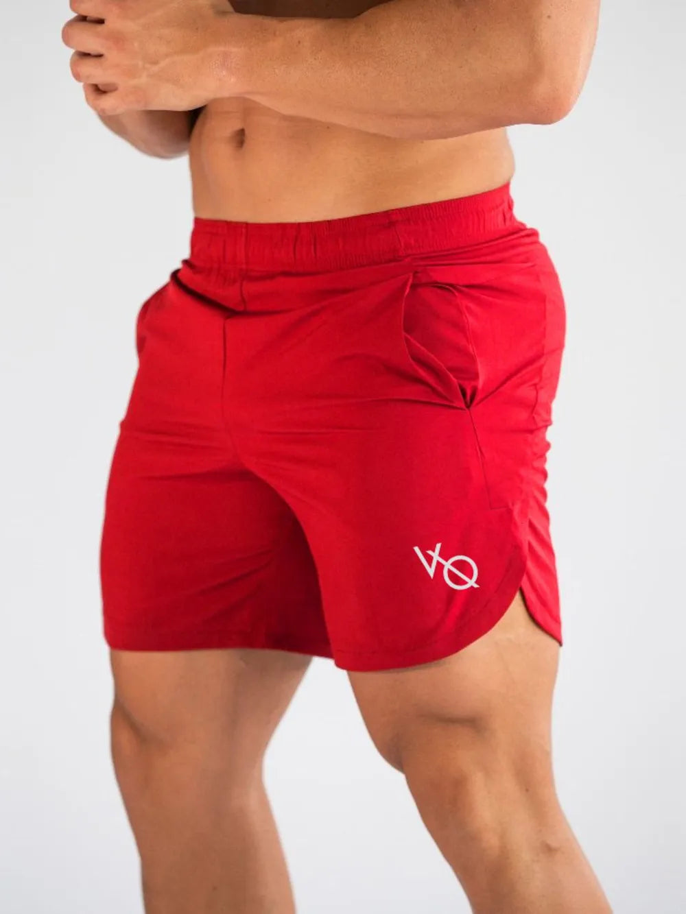 Men's red elastic waist active shorts, stretchy polyester-spandex blend.