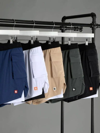 Men's plus size drawstring shorts in blue, white, beige, green, and black hanging on a rack.