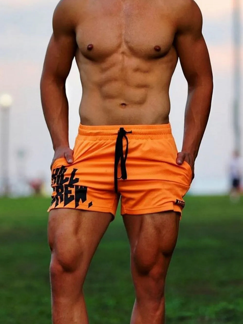 Men's plus size drawstring active shorts in orange, featuring moderate stretch polyester-spandex blend.