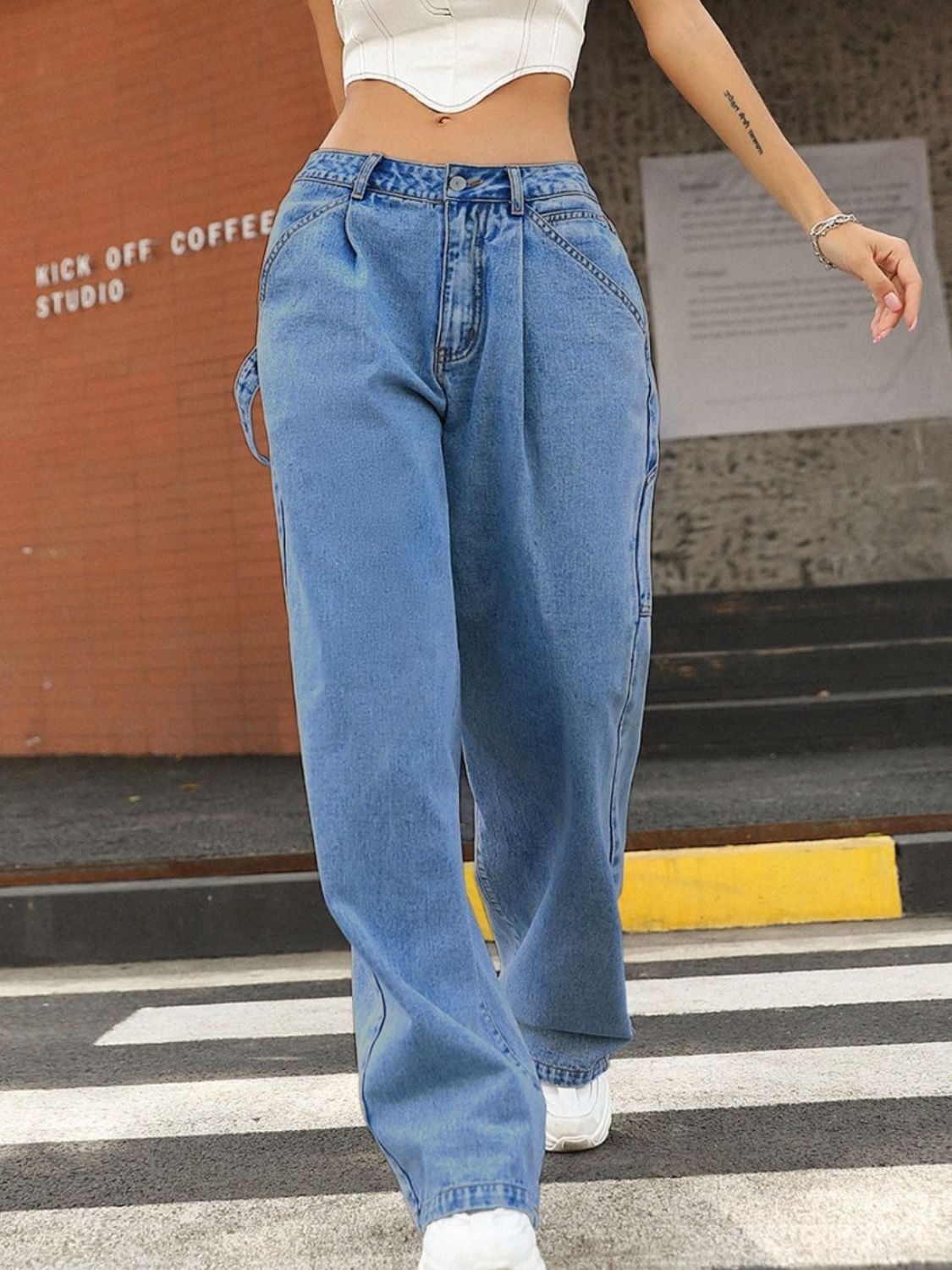 Wide leg jeans with pockets, low waist, buttoned style.