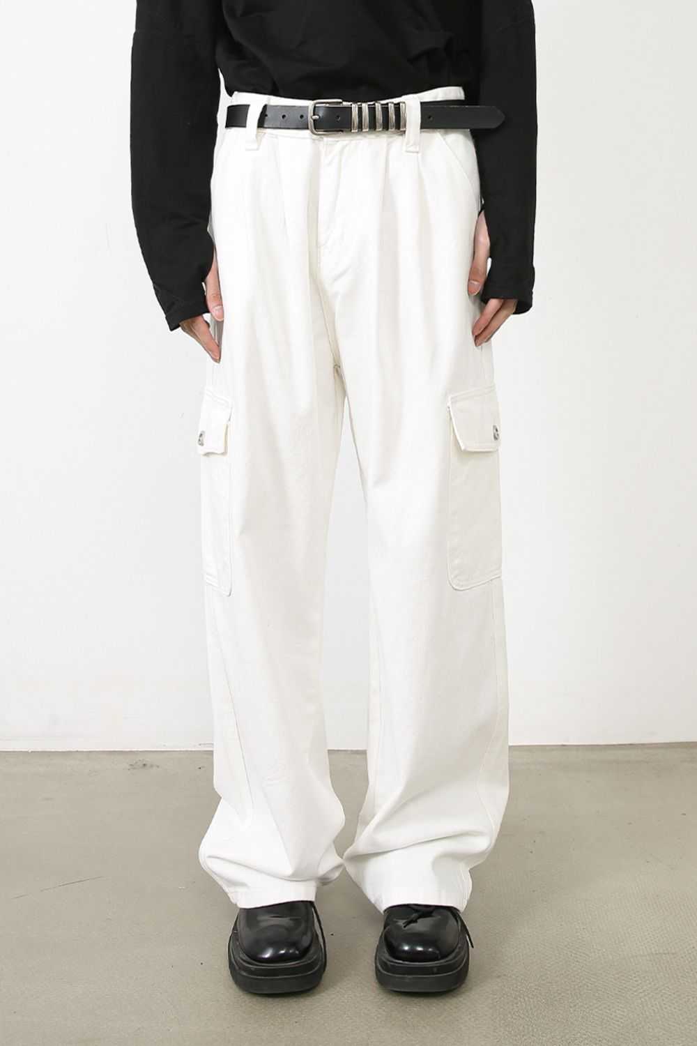 Men's loose fit cargo jeans in white with multiple pockets and no stretch.