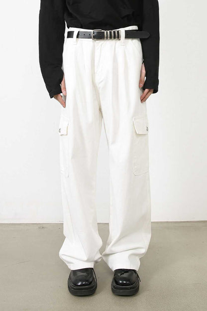 Men's loose fit cargo jeans in white with multiple pockets and no stretch.