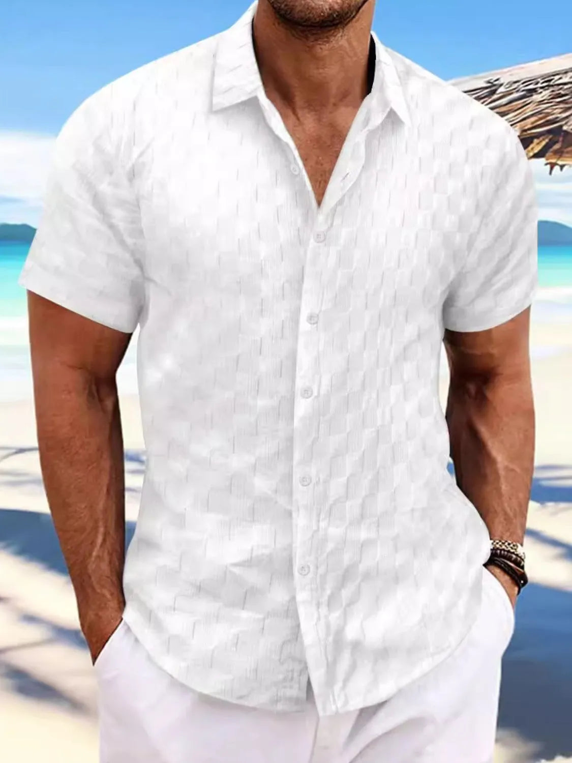 Men's full size button-up short sleeve shirt, white, worn outdoors by the beach.