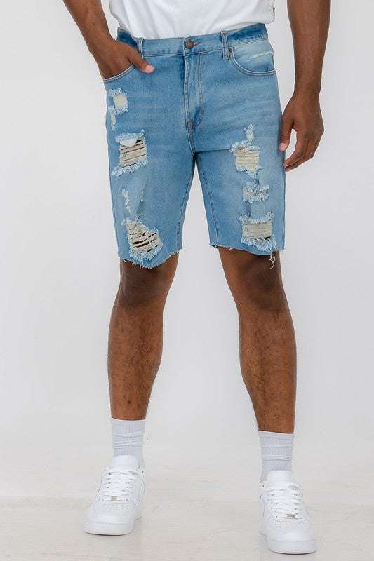 Distressed stretch denim shorts with 10" inseam and slim fit.