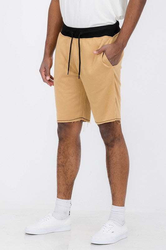 WeRaw Cut Sweat Shorts featuring raw cut hem, elastic waist with drawstring, regular fit, above the knee, cotton-polyester blend.